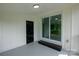 Inviting sunroom with white walls, a sliding glass door, and a serene view of the outdoors at 4914 Ridgeley Dr, Charlotte, NC 28208