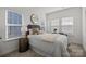 Inviting bedroom with neutral tones, stylish furnishings, and natural light from the windows at 5004 Cherry Gum Ct # 43, Matthews, NC 28105