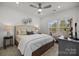 Bright bedroom showcasing a cozy bed, ceiling fan, and windows offering abundant natural light at 5004 Cherry Gum Ct # 43, Matthews, NC 28105