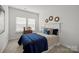 Cozy bedroom with a neatly made bed featuring a navy blue quilt, two windows, and neutral-toned walls at 5004 Cherry Gum Ct # 43, Matthews, NC 28105