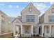 Charming two-story home with gray siding, white trim, covered entry, and manicured landscaping at 5004 Cherry Gum Ct # 43, Matthews, NC 28105