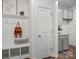 Functional mudroom with bench, hooks, and storage, conveniently located near a door and cabinets at 5004 Cherry Gum Ct # 43, Matthews, NC 28105