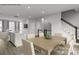 Open dining area with modern table set, flowing into the living room and kitchen at 5030 Grain Orchard Rd # 3025C, Indian Trail, NC 28079