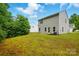 Lush backyard with mature trees, offering a private and serene outdoor retreat at 6322 Sydney Mae Ln, Charlotte, NC 28262