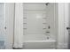 Clean bathroom featuring a bathtub with white tile surround and convenient shower storage shelves at 6322 Sydney Mae Ln, Charlotte, NC 28262