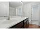 Well-lit bathroom with double vanity sinks, white countertops, and a separate toilet room at 6322 Sydney Mae Ln, Charlotte, NC 28262