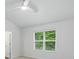 Bright bedroom featuring neutral carpet and a window with a view of a lush green yard at 6322 Sydney Mae Ln, Charlotte, NC 28262