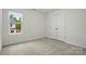 Bright bedroom with neutral carpet, closet, and natural light from the window at 6322 Sydney Mae Ln, Charlotte, NC 28262