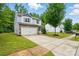 A well-manicured lawn and a paved driveway lead up to this beautiful two-story home at 6322 Sydney Mae Ln, Charlotte, NC 28262