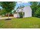 Charming two-story home featuring stone accents, light gray siding, a well-manicured lawn, and an attached two-car garage at 6322 Sydney Mae Ln, Charlotte, NC 28262