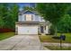 Charming two-story home boasts stone accents, a two-car garage, and a well-maintained front yard at 6322 Sydney Mae Ln, Charlotte, NC 28262