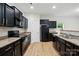 Beautiful kitchen featuring dark cabinets, laminate countertops and stainless steel appliances at 6322 Sydney Mae Ln, Charlotte, NC 28262