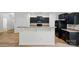 Modern kitchen featuring a breakfast bar, black cabinets, and stainless steel appliances at 6322 Sydney Mae Ln, Charlotte, NC 28262