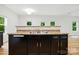 Kitchen island with a double sink and black cabinets, perfect for food preparation at 6322 Sydney Mae Ln, Charlotte, NC 28262
