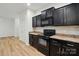 Modern kitchen with black appliances, granite countertops, and tile backsplash at 6322 Sydney Mae Ln, Charlotte, NC 28262