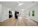 Open-concept living room with modern flooring, neutral walls, and a view of the kitchen at 6322 Sydney Mae Ln, Charlotte, NC 28262