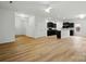 Open-concept living room with modern flooring and a view into the kitchen with dark cabinetry at 6322 Sydney Mae Ln, Charlotte, NC 28262