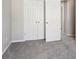 Bedroom with double closet doors, carpeting and view to the hallway at 6332 Sackett Way, Charlotte, NC 28269