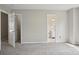 Carpeted bedroom featuring open doors that reveal views of a hallway and bathroom at 6332 Sackett Way, Charlotte, NC 28269