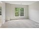 Bright and airy bedroom featuring a large window and plush carpeting at 6332 Sackett Way, Charlotte, NC 28269