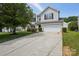 Well-maintained home with an expansive driveway leading to an attached two-car garage at 6332 Sackett Way, Charlotte, NC 28269
