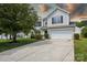 Charming two-story home with a well-manicured lawn and a spacious driveway leading to an attached two-car garage at 6332 Sackett Way, Charlotte, NC 28269