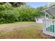 Backyard with an American flag, large trees, and a shed at 653 Turner St, Mooresville, NC 28115