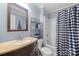 Bathroom with a vanity, mirror, and a shower with a checkered curtain at 653 Turner St, Mooresville, NC 28115