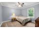 Serene bedroom with neutral walls, soft carpet, and a window, creating a peaceful and inviting space at 653 Turner St, Mooresville, NC 28115
