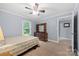 Cozy bedroom featuring neutral walls, wood furniture, and a large window providing natural light at 653 Turner St, Mooresville, NC 28115