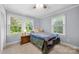 Cozy bedroom featuring natural light from two windows and a ceiling fan at 653 Turner St, Mooresville, NC 28115