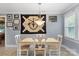 Well-lit dining area with a unique wall hanging, complemented by a classic white table and chairs at 653 Turner St, Mooresville, NC 28115
