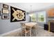 Bright dining area with a four-chair table, neutral walls, and view to the outside through two windows at 653 Turner St, Mooresville, NC 28115