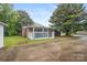 Exterior view of a brick home with a covered porch and driveway at 653 Turner St, Mooresville, NC 28115