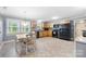 Eat-in kitchen with stainless steel appliances and light wood cabinets, complemented by neutral walls and a dining area at 653 Turner St, Mooresville, NC 28115