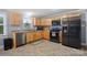 Updated kitchen with modern stainless steel appliances and beautiful wood cabinets, offering style and functionality at 653 Turner St, Mooresville, NC 28115