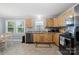 Modern eat-in kitchen featuring stainless steel appliances, light wood cabinets, and bright natural light at 653 Turner St, Mooresville, NC 28115