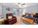 Spacious living room with comfortable leather seating, neutral walls, and multiple doorways leading to other rooms at 653 Turner St, Mooresville, NC 28115