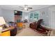 Inviting living room with a brick fireplace, plush leather furniture, and a ceiling fan providing ample lighting at 653 Turner St, Mooresville, NC 28115