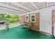 Covered porch with outdoor seating, brick wall, and a door at 653 Turner St, Mooresville, NC 28115