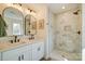 Bathroom features double vanity, framed mirrors, modern fixtures and luxurious walk-in shower with marble tiling at 709 Catawba St, Lincolnton, NC 28092