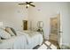 Cozy bedroom with vaulted ceiling, ceiling fan, natural light, a decorative mirror, and a stylish ensuite bathroom at 709 Catawba St, Lincolnton, NC 28092
