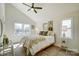 Bright bedroom featuring vaulted ceiling, ceiling fan, large windows with a comfortable bed and stylish decor at 709 Catawba St, Lincolnton, NC 28092