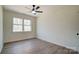 Simple bedroom design with natural lighting, neutral paint, wood-look floors, and ceiling fan at 709 Catawba St, Lincolnton, NC 28092