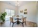 Cozy dining area with a round table, modern chairs, and sliding glass doors leading to outdoor area at 709 Catawba St, Lincolnton, NC 28092
