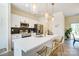 Modern kitchen with white cabinetry, stainless steel appliances, and a quartz countertop island with seating at 709 Catawba St, Lincolnton, NC 28092