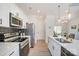 Contemporary kitchen featuring stainless steel appliances, white cabinets, and a black backsplash at 709 Catawba St, Lincolnton, NC 28092