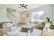 Bright living room with a large window, plush sofa, and access to the staircase at 709 Catawba St, Lincolnton, NC 28092