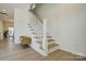 Bright stairway featuring a charming design and neutral color palette, complemented by wood-look flooring at 709 Catawba St, Lincolnton, NC 28092