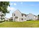 Backyard view of the house with vinyl siding and a grassy lawn at 7212 Ravanna Dr, Charlotte, NC 28213